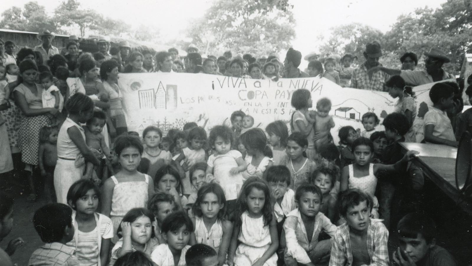 The village of Copapayo sitting in front of a banner from Columbus