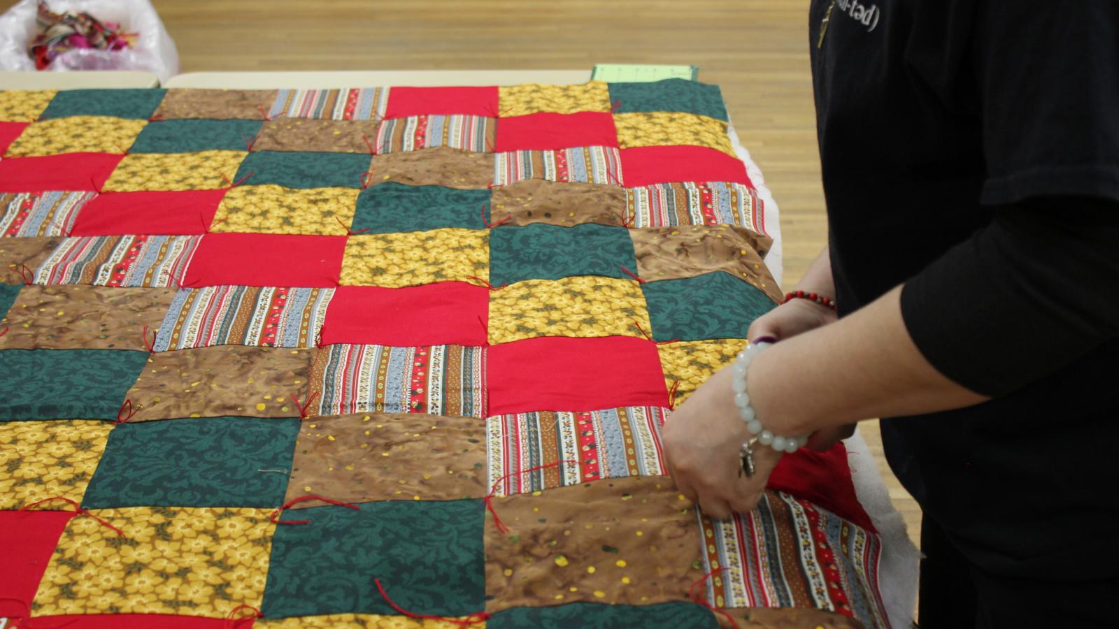 Espinal helps church women with quilts