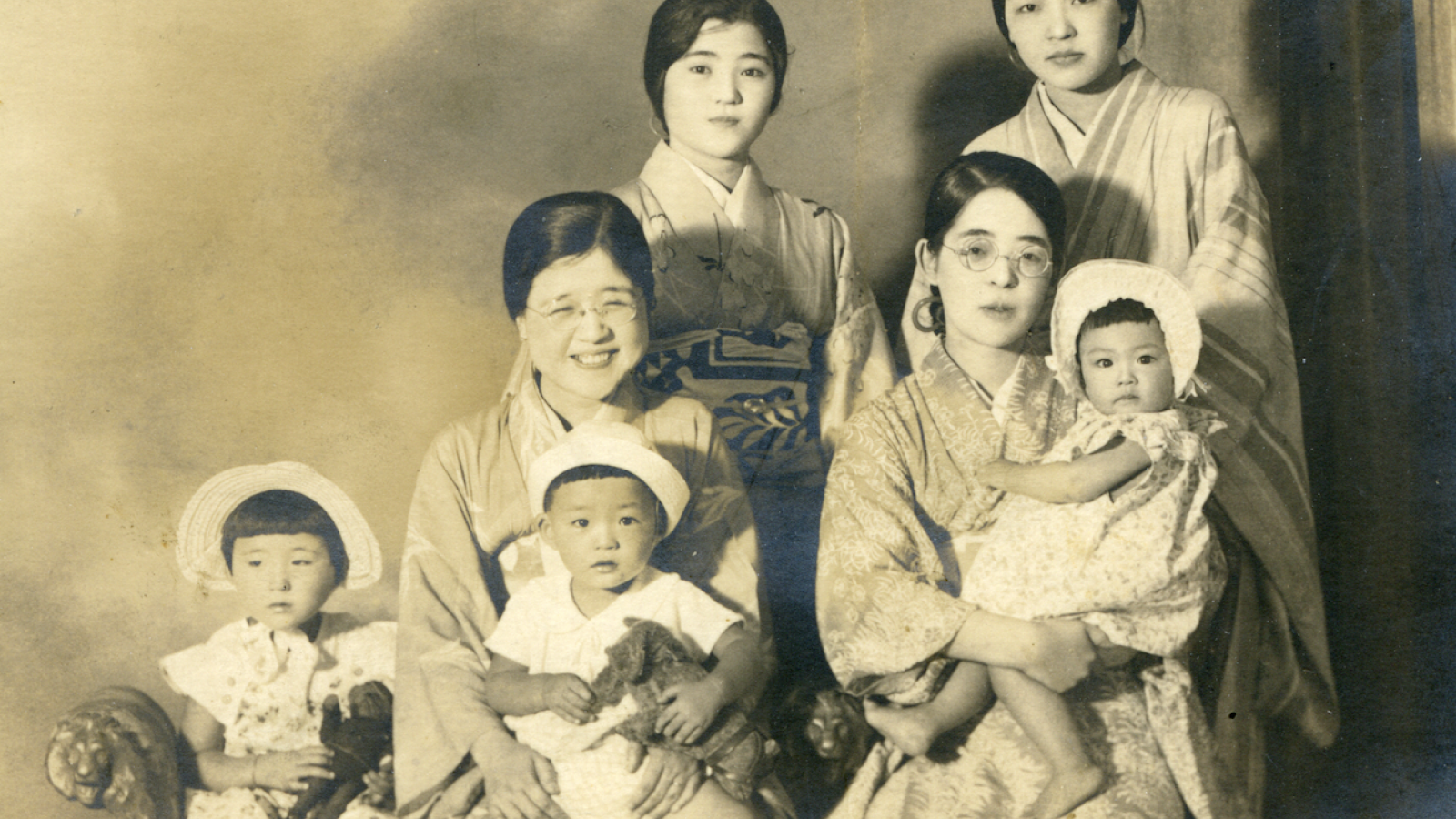 Black and white photo of Sakaoka as baby with family